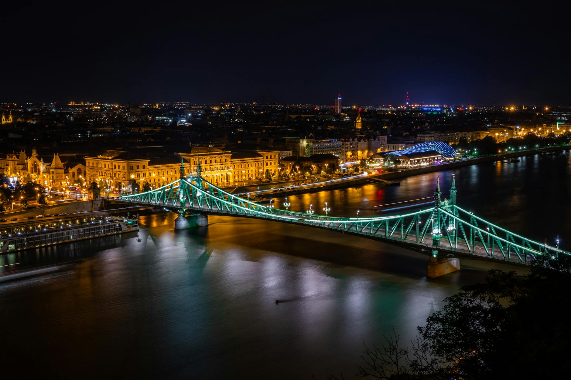 Nocny widok na oświetlony Most Wolności nad Dunajem w Budapeszcie